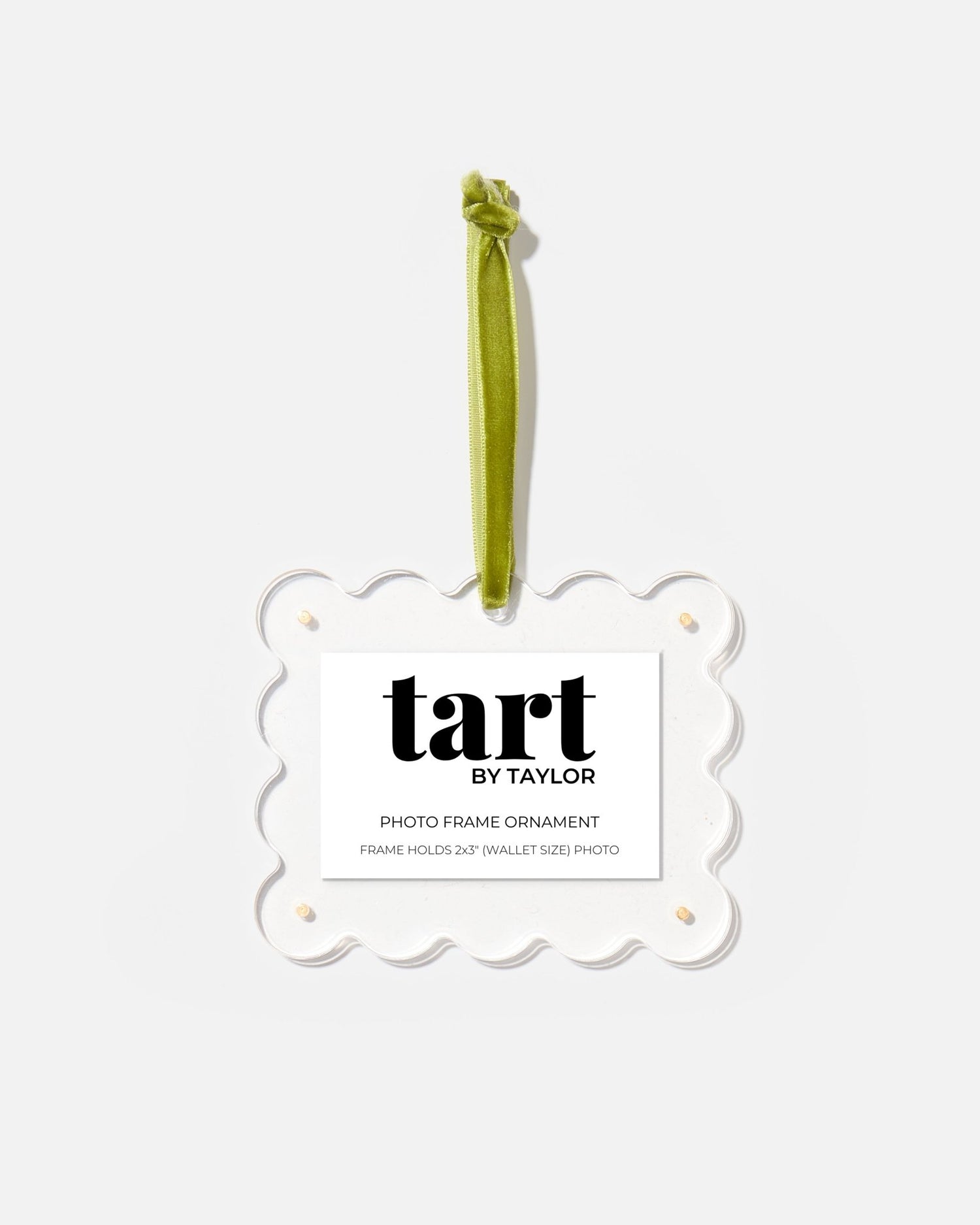 Decorative photo frame ornament with green ribbon and 'tart by Taylor' label on a white background