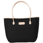 Black tote bag with beige handles and trim on a transparent background