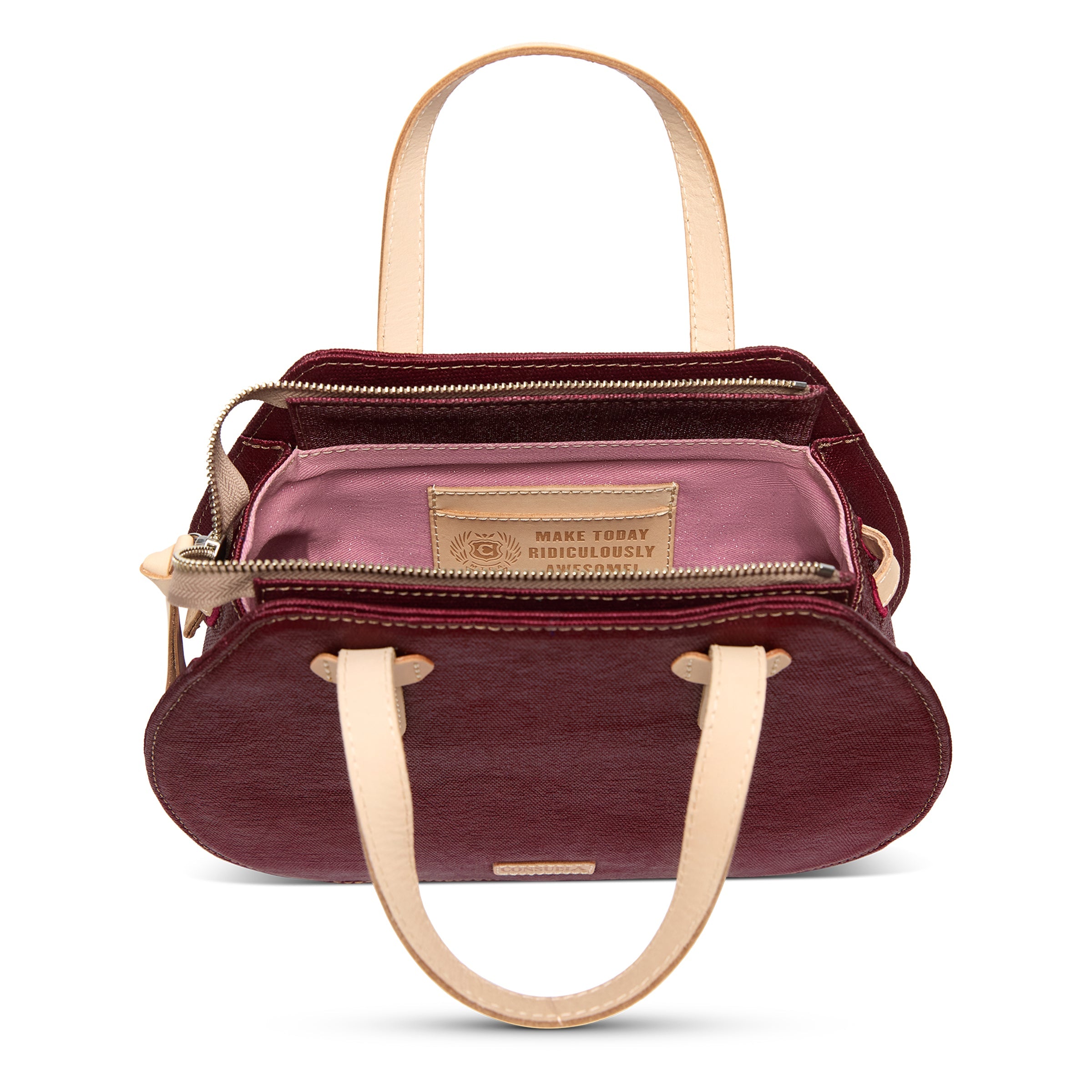 Maroon handbag with beige handles and trim on a white background
