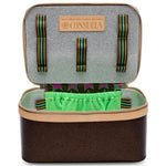 Open Consuela travel case with green interior lining on a white background