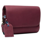 Consuela Plum On The Town Crossbody featuring a deep plum exterior, compact silhouette, and hands-free adjustable strap.