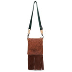 Brown leather crossbody bag with fringe and green strap on a white background