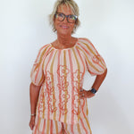 Woman wearing a patterned outfit with a white background