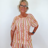 Woman wearing a patterned outfit with a white background