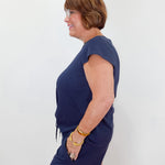 Woman wearing a navy blue dress against a white background