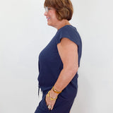 Woman wearing a navy blue dress against a white background