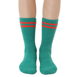 Green socks with red stripes worn by a person on a white background