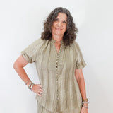 Woman wearing a green outfit against a white background