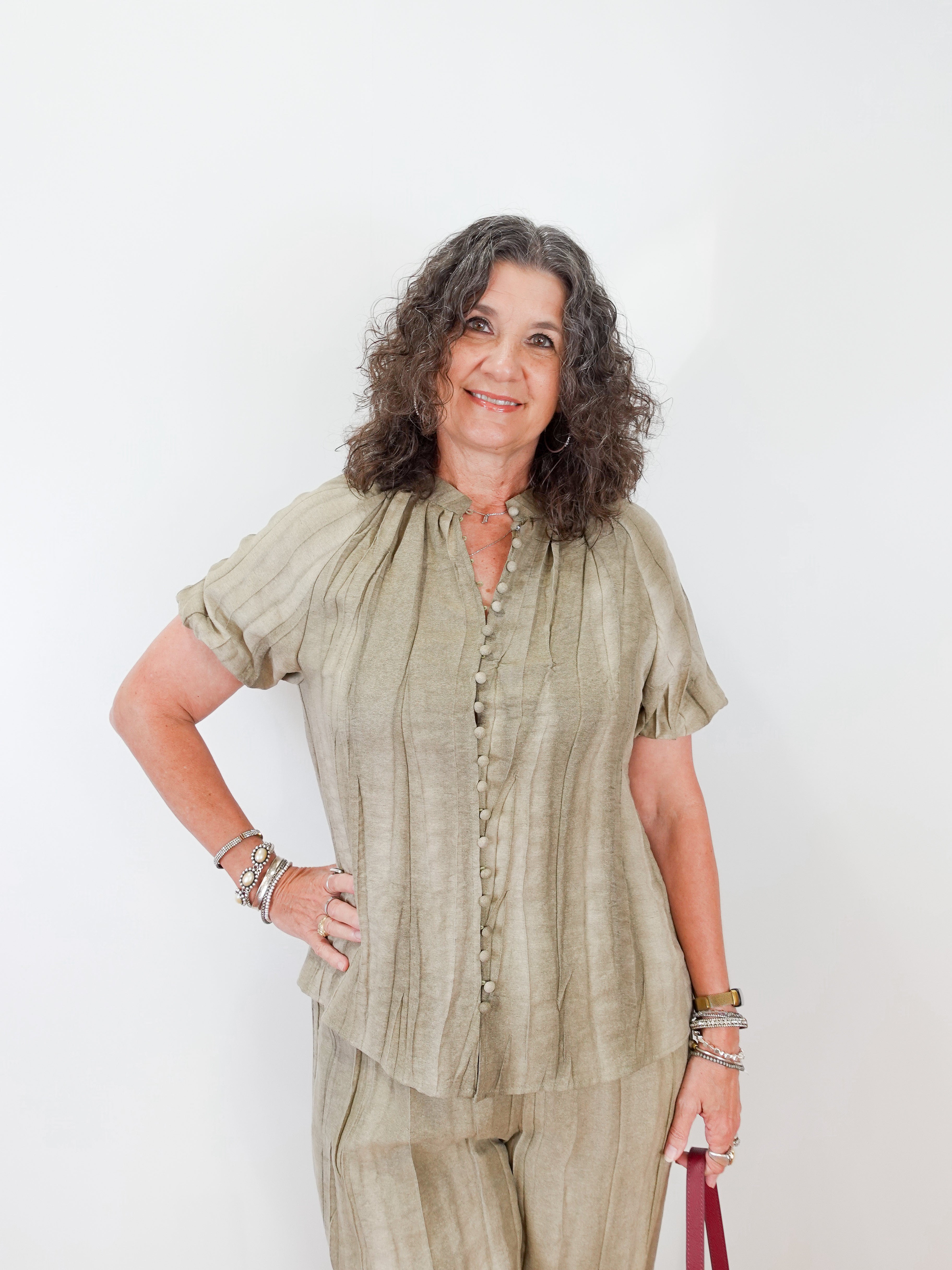 Woman wearing a green outfit against a white background