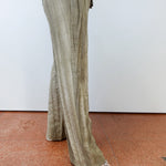 Person wearing light-colored wide-leg pants on a plain background