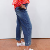 Woman wearing cropped wide leg pants with front patch pockets and a relaxed fit.