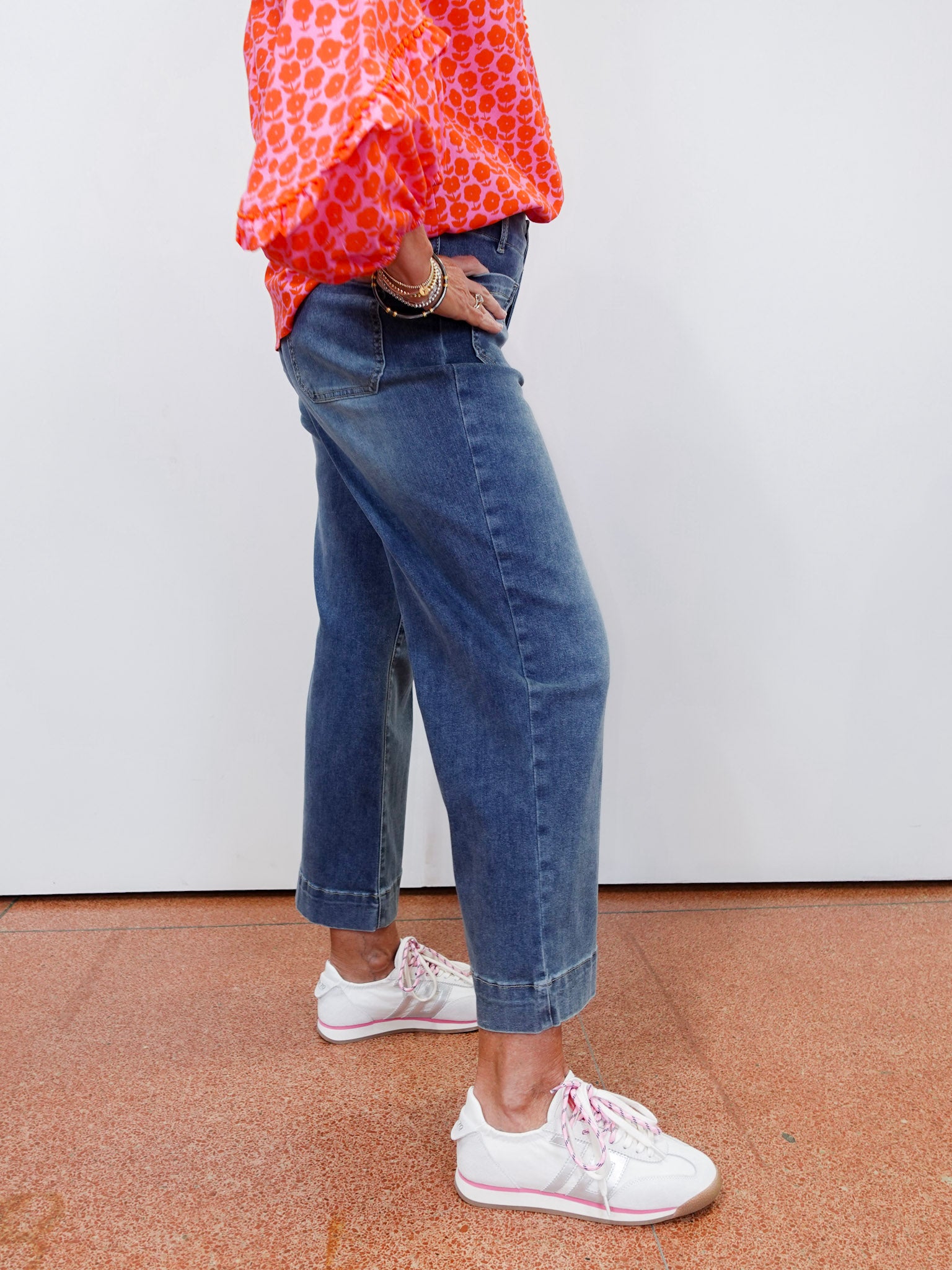 Woman wearing cropped wide leg pants with front patch pockets and a relaxed fit.