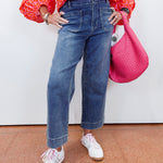 Woman wearing cropped wide leg pants with front patch pockets and a relaxed fit.