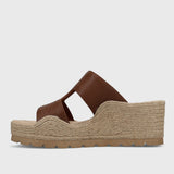Brown sandal with jute sole on a light gray background