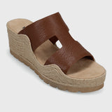 Brown wedge sandal with jute sole on a light gray background