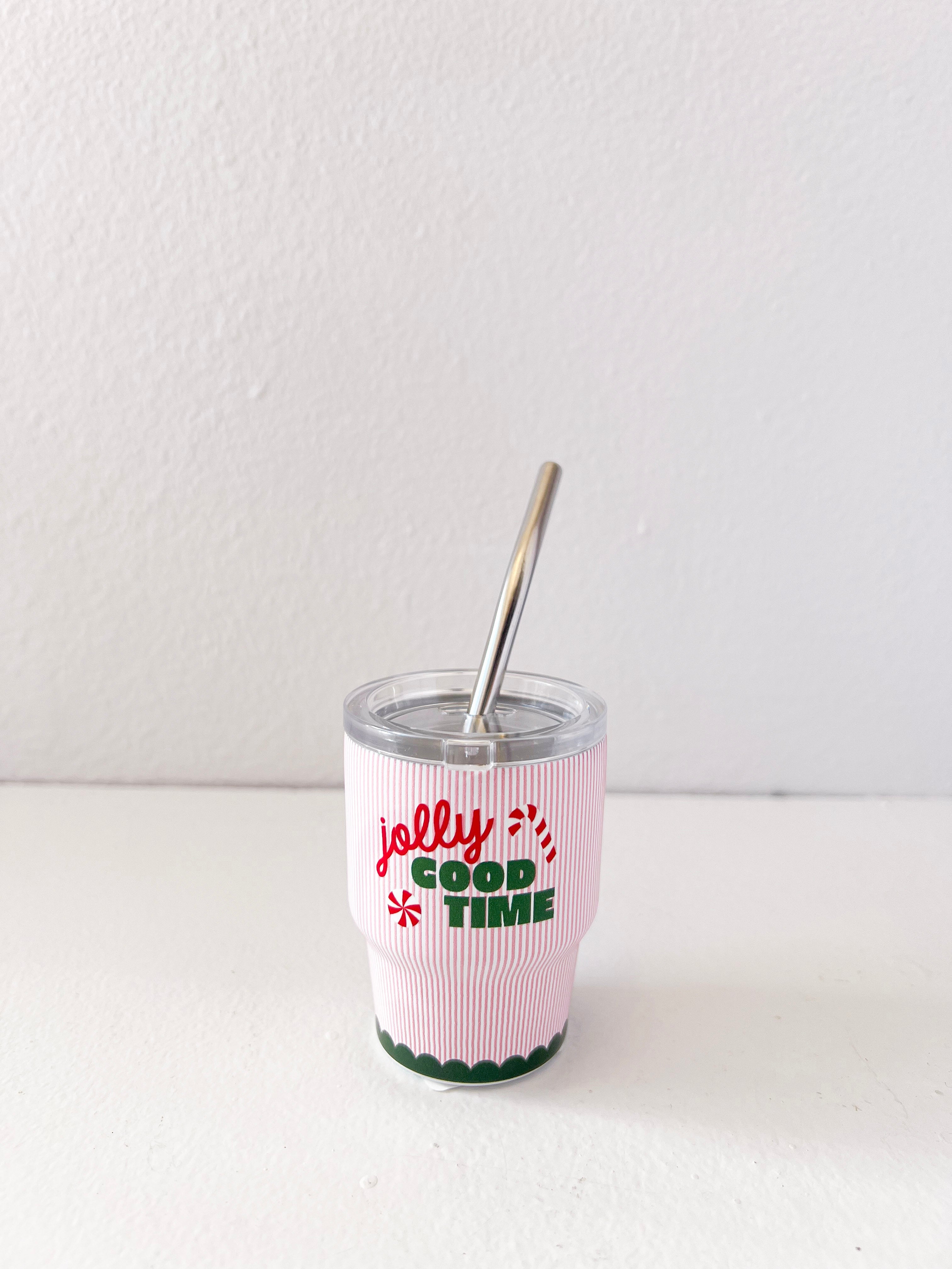 Tumbler with 'Jolly Good Time' text and pink sleeve on a white background