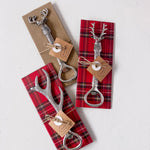Set of three silver bottle openers with deer heads on plaid paper packaging.