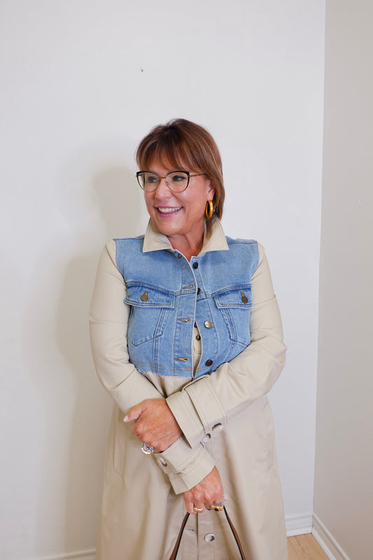 woman wearing a denim mix trench coat against a white background. 