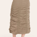 Beige ruched skirt worn by a person on a white background