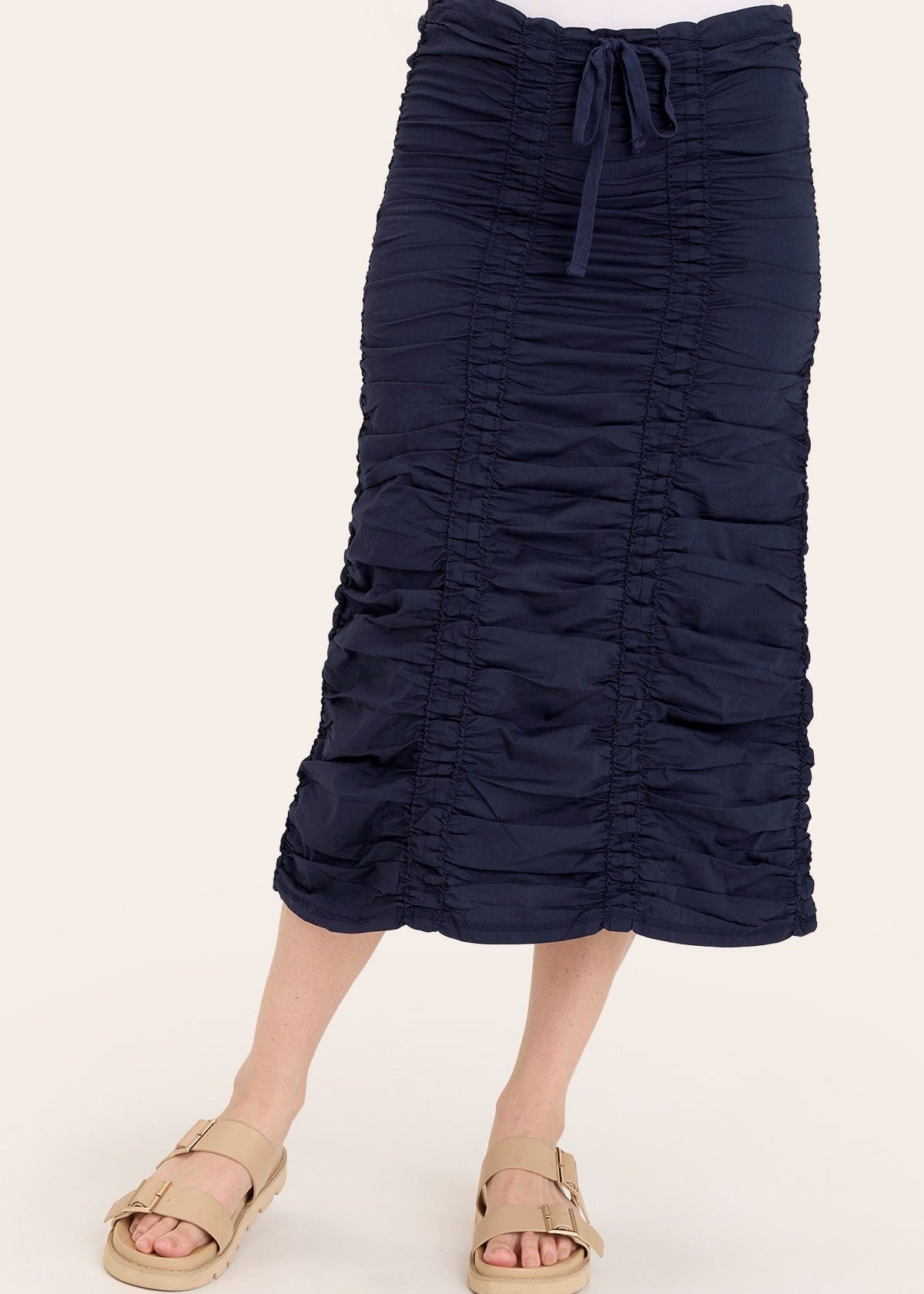 Navy blue ruched skirt worn by a person on a white background