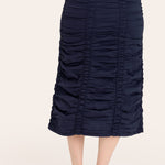 Navy blue ruched skirt worn by a person on a white background