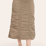 Person wearing a beige ruched skirt on a white background