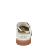White sneaker with brown sole on a white background