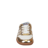 A single low-top sneaker shown from the side profile on a plain white background. The shoe features a white leather base with metallic gold leather overlays, white laces, and a brown gum sole.