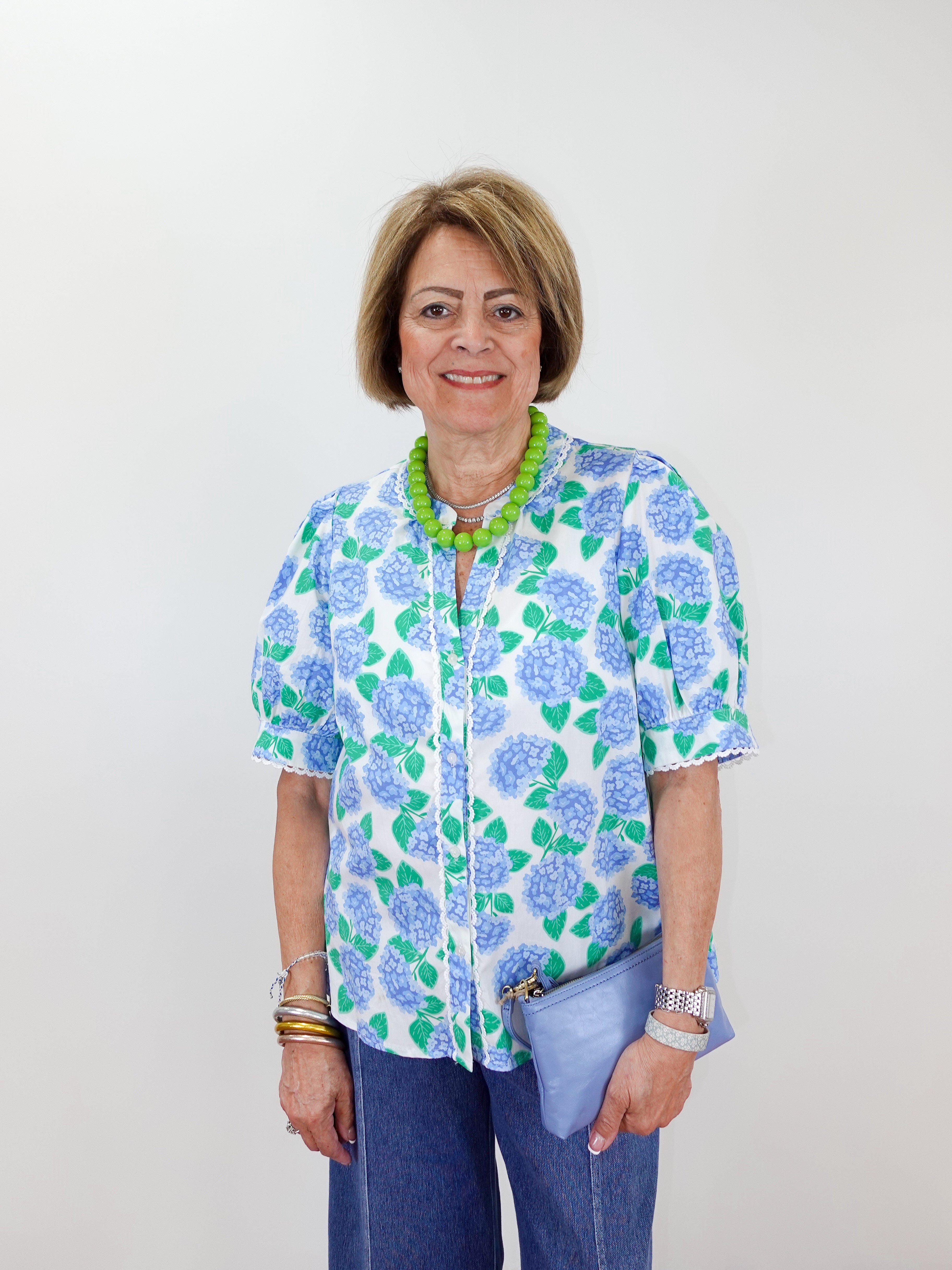 Woman wearing a floral blouse with a plain background