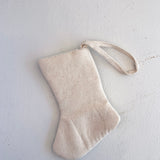 Beige fabric stocking on a light gray background