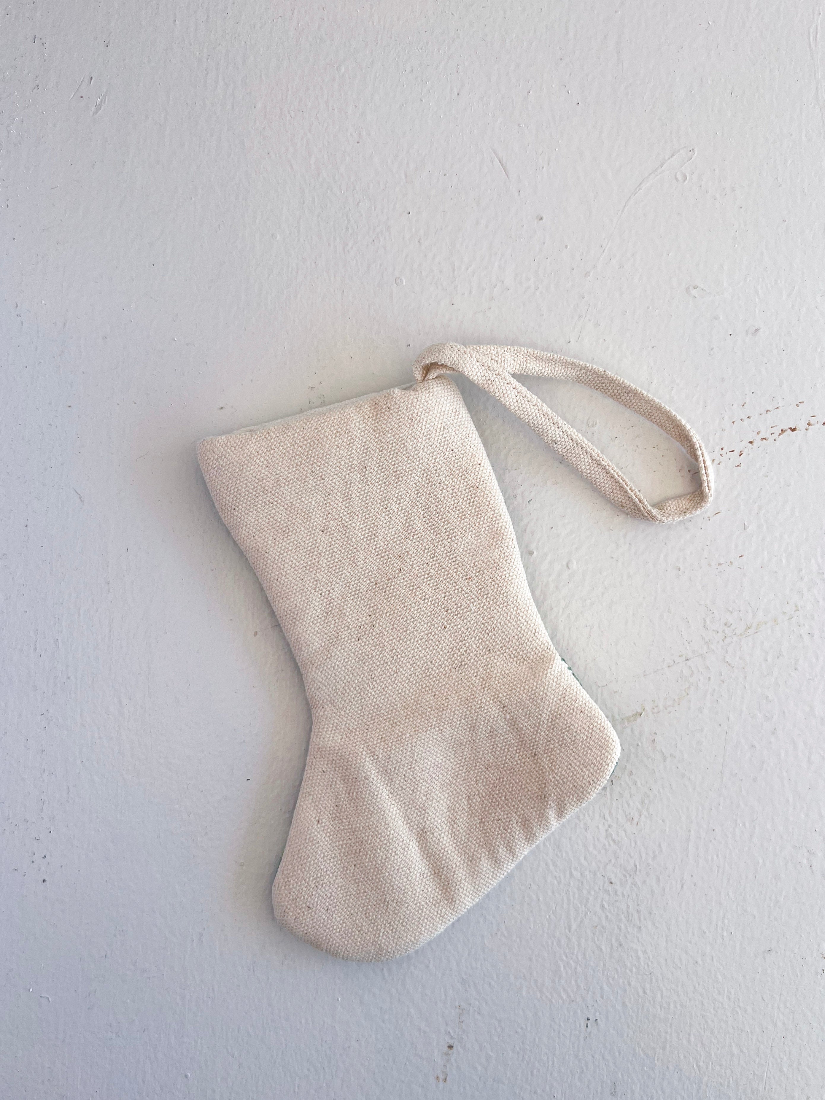 Beige fabric stocking on a light gray background