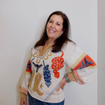 Woman wearing a colorful sweater with patterns on a white background
