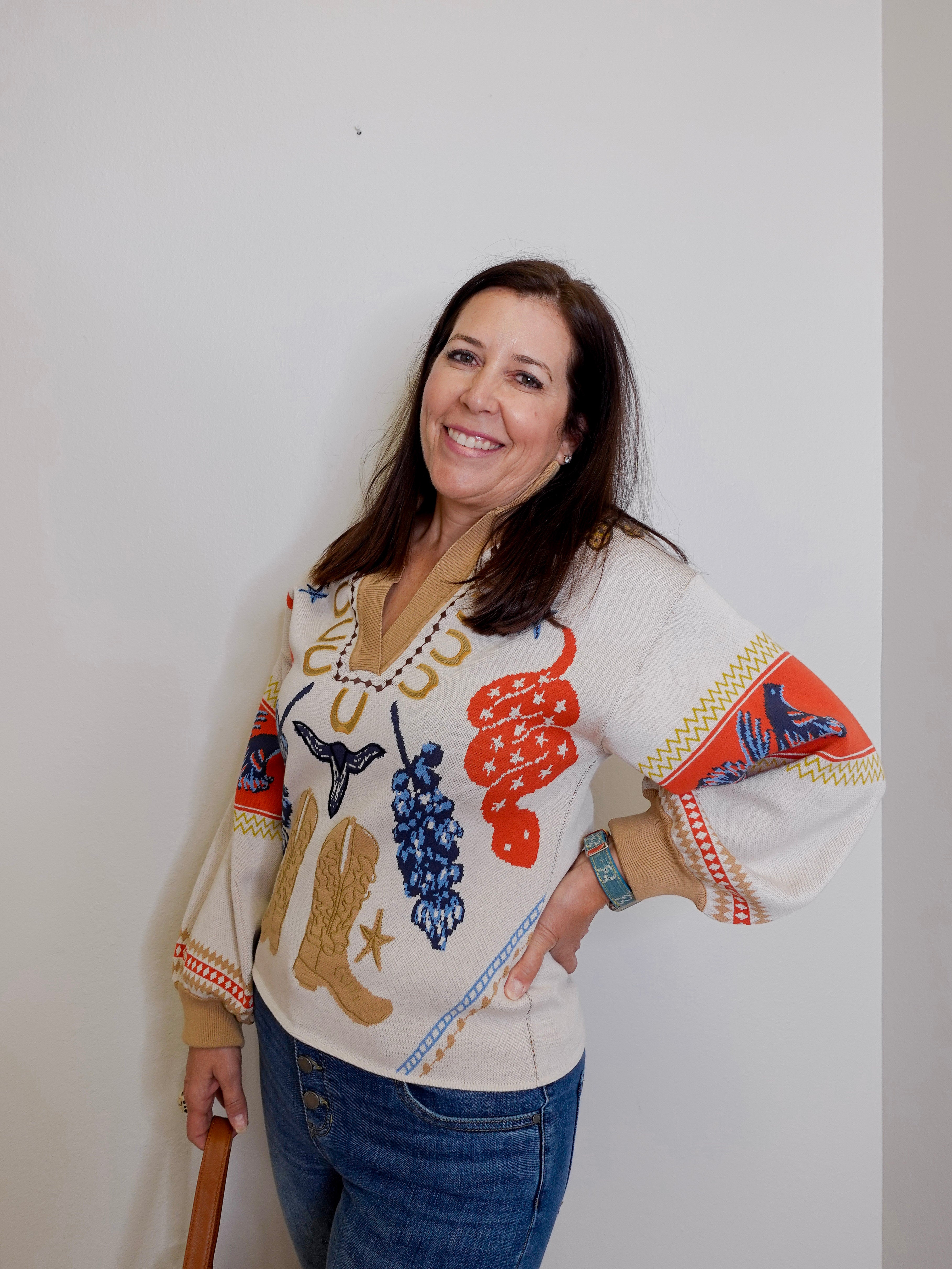 Woman wearing a colorful sweater with patterns on a white background