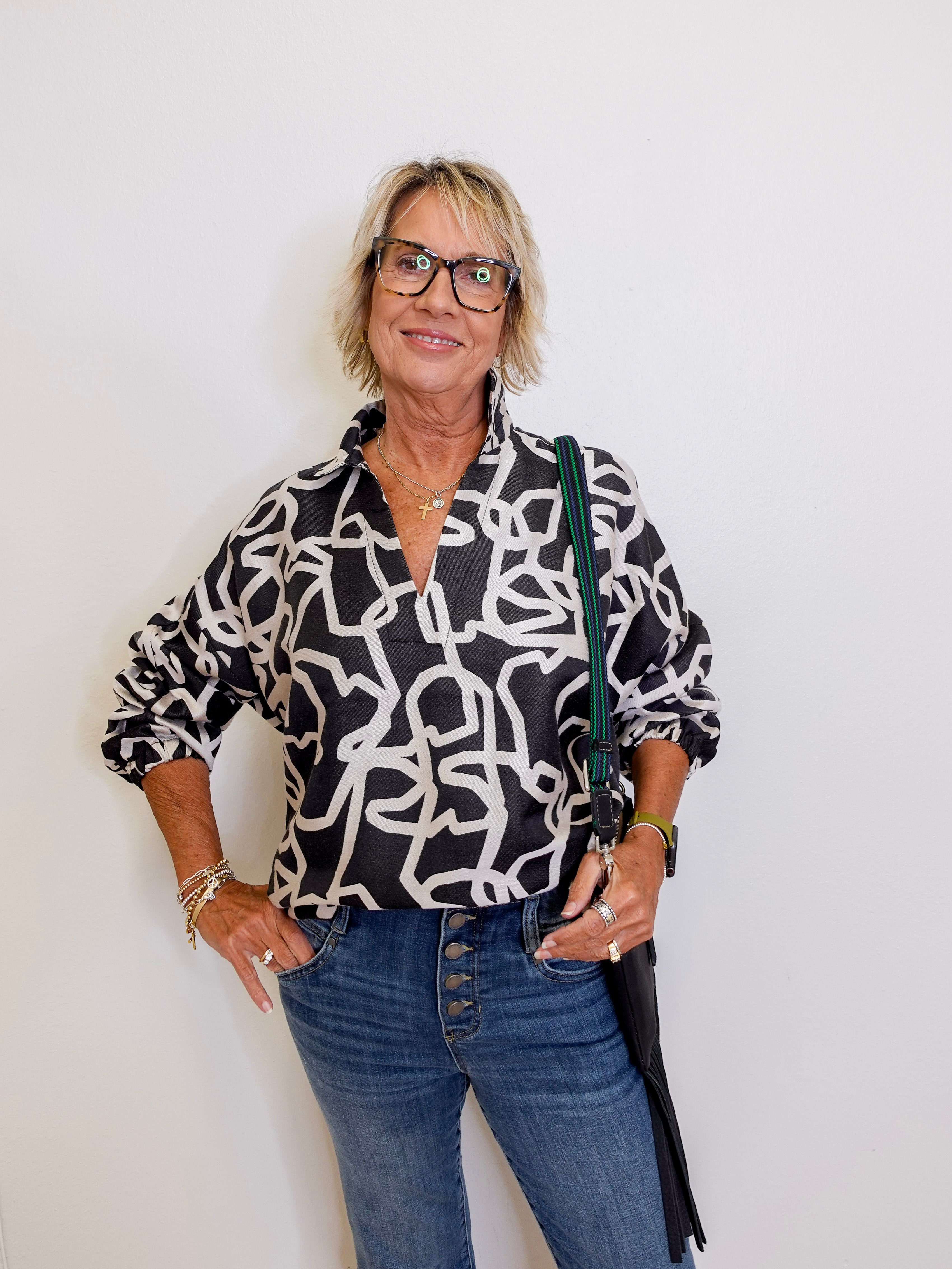 woman wearing a black and white long sleeve top from Emily McCarthy. 