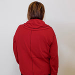 Person wearing a red jacket against a white background