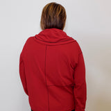 Person wearing a red jacket against a white background