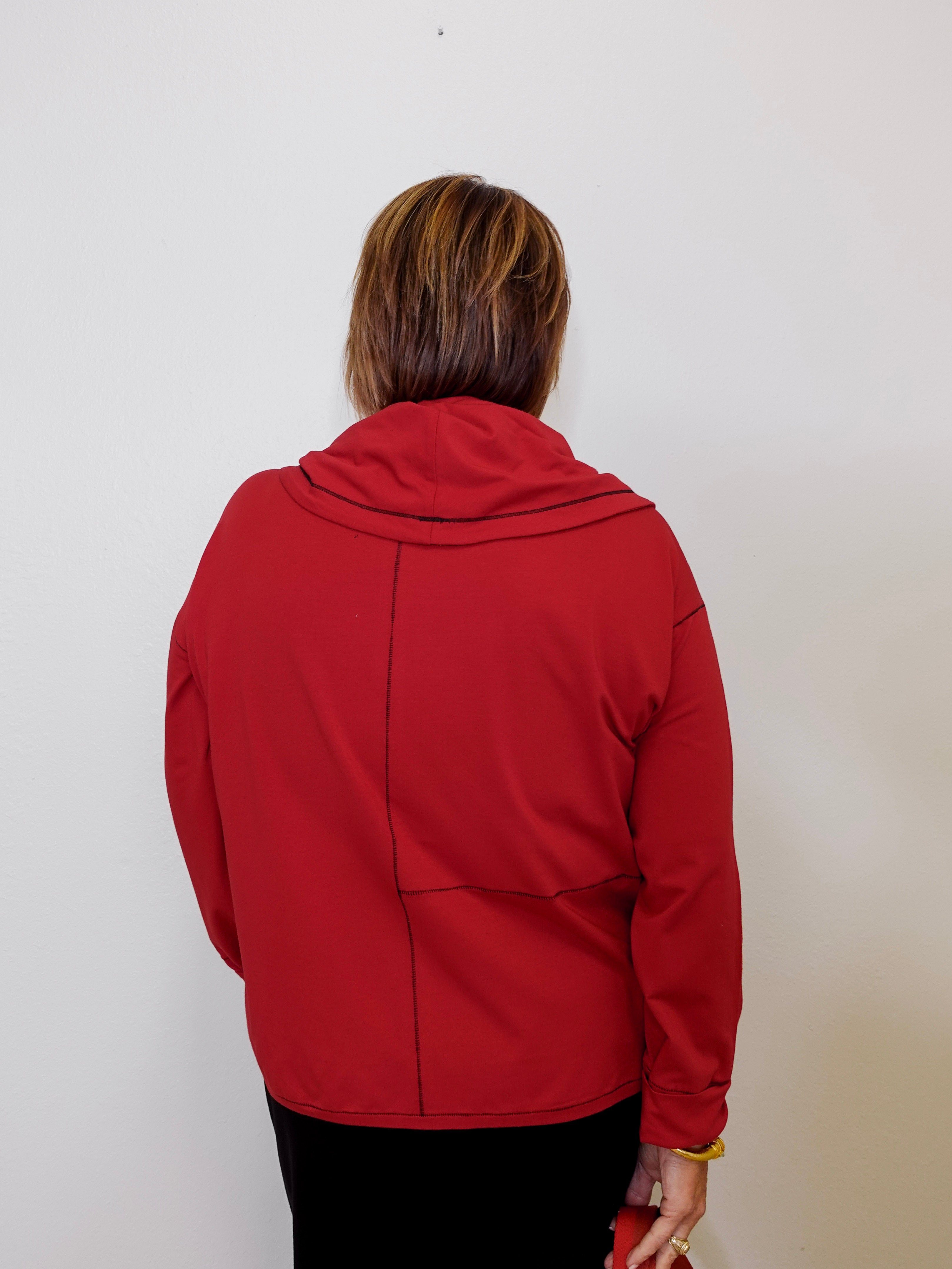 Person wearing a red jacket against a white background