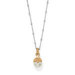 Necklace with a gold and pearl pendant on a white background