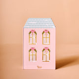 Pink gift box with window illustrations and bows on a beige background