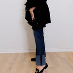 Person wearing a black outfit with a white background