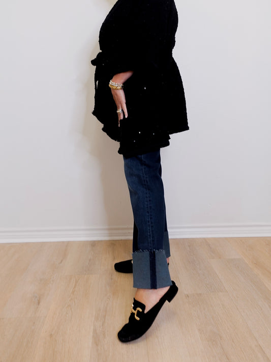 Person wearing a black outfit with a white background