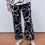 Woman wearing the FDJ Suzanne printed boot crop pant with a black and white abstract print.