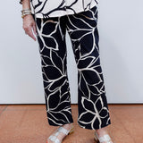 Woman wearing the FDJ Suzanne printed boot crop pant with a black and white abstract print.
