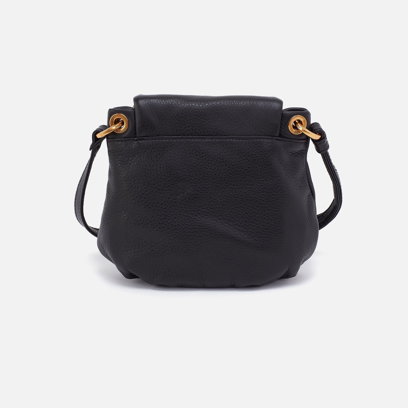 Black leather handbag with gold hardware on a light gray background