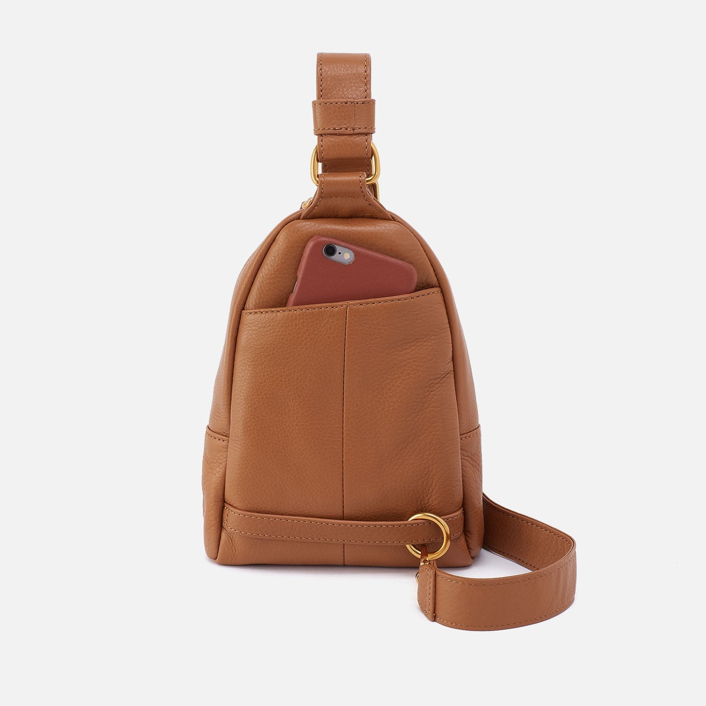 Hobo Fern Sling in warm honey leather with adjustable strap and zip closure.