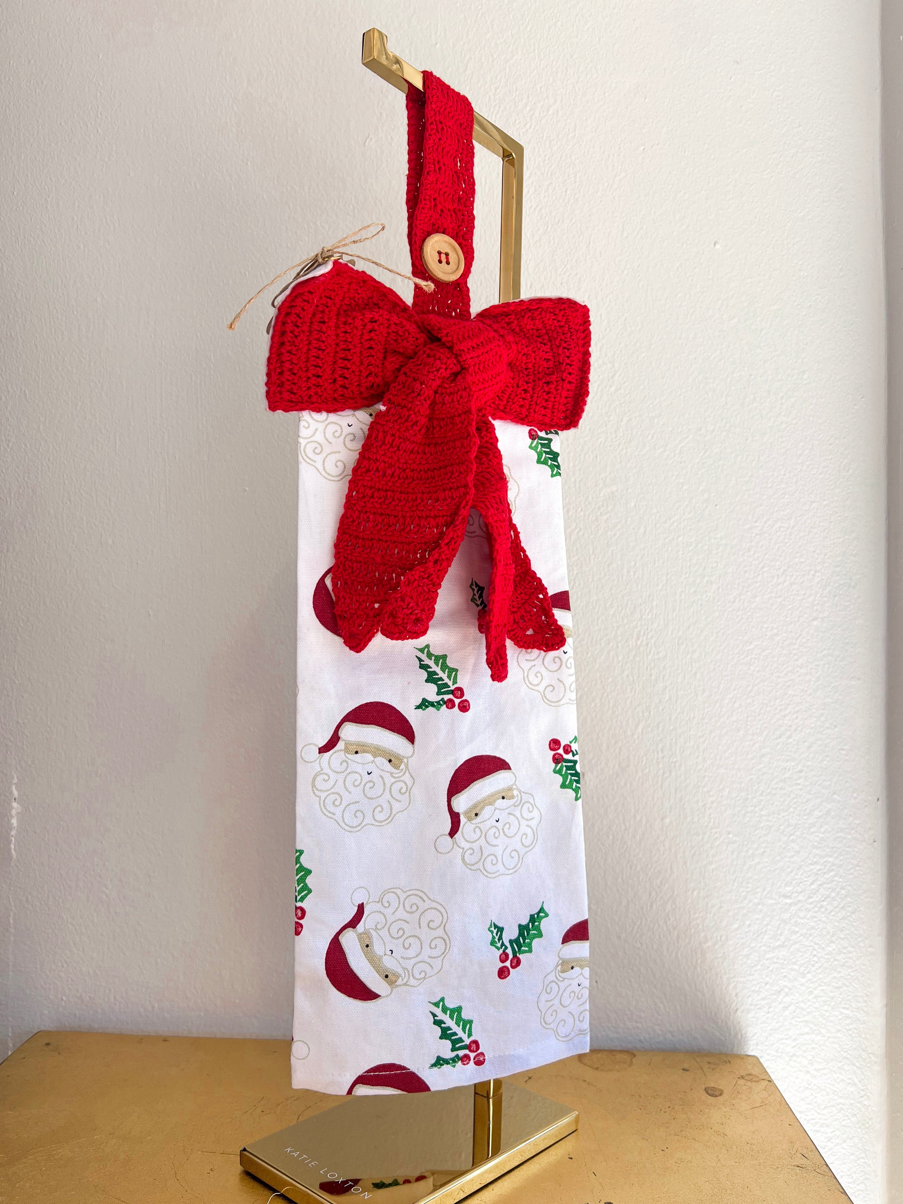 Gift bag with red knitted bow and patterned design on a white background