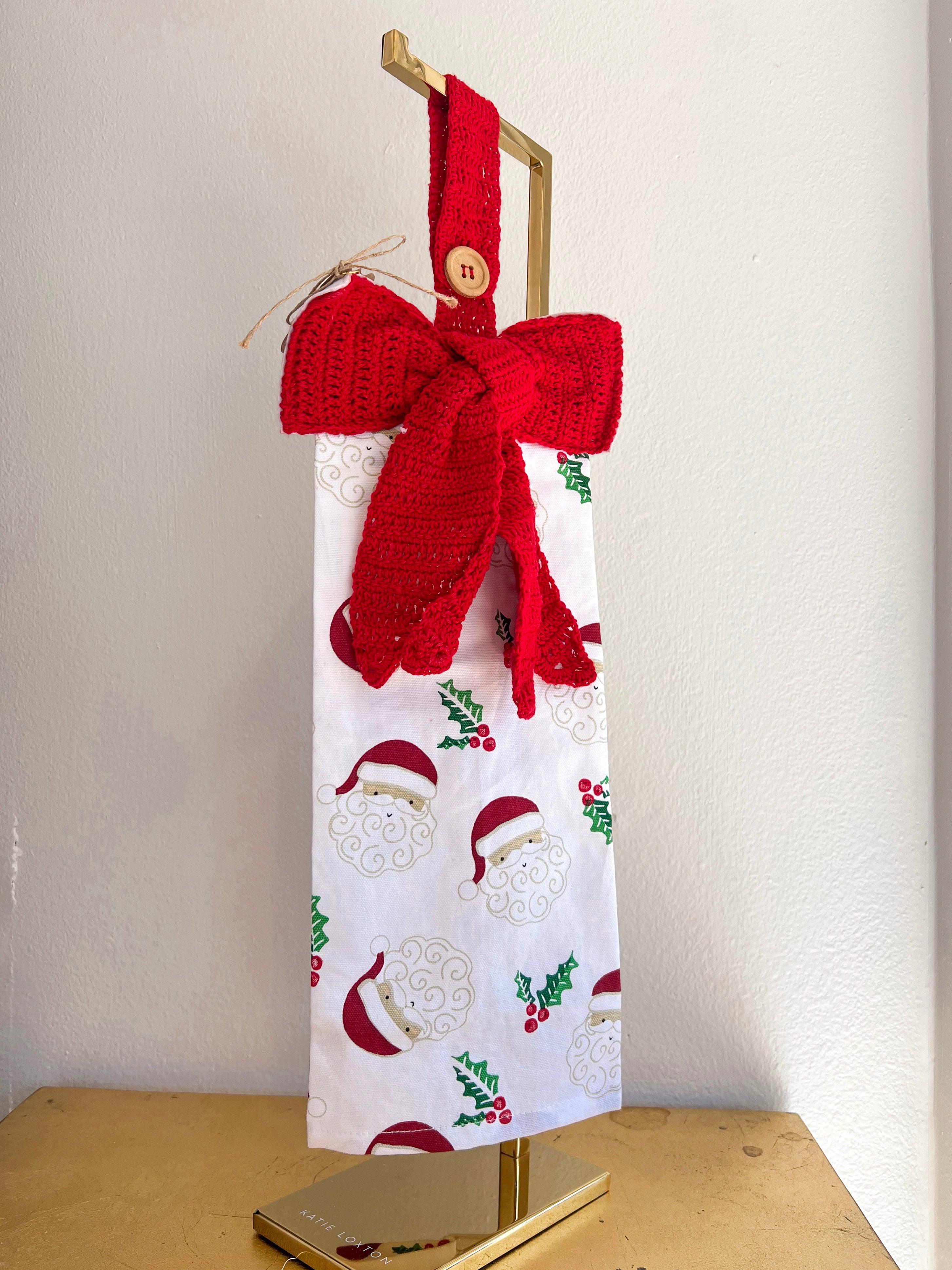 Gift bag with red knitted bow and patterned design on a white background