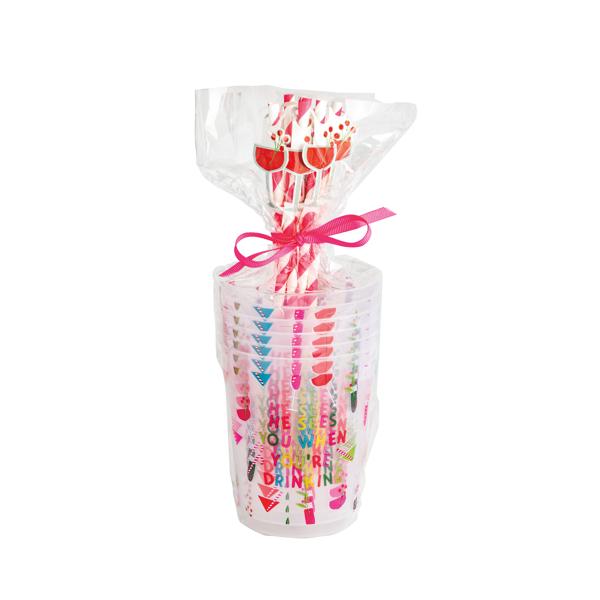 Bottle of wine wrapped in colorful paper with a pink bow on a white background
