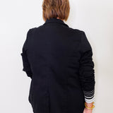 Person wearing a black jacket with a white background