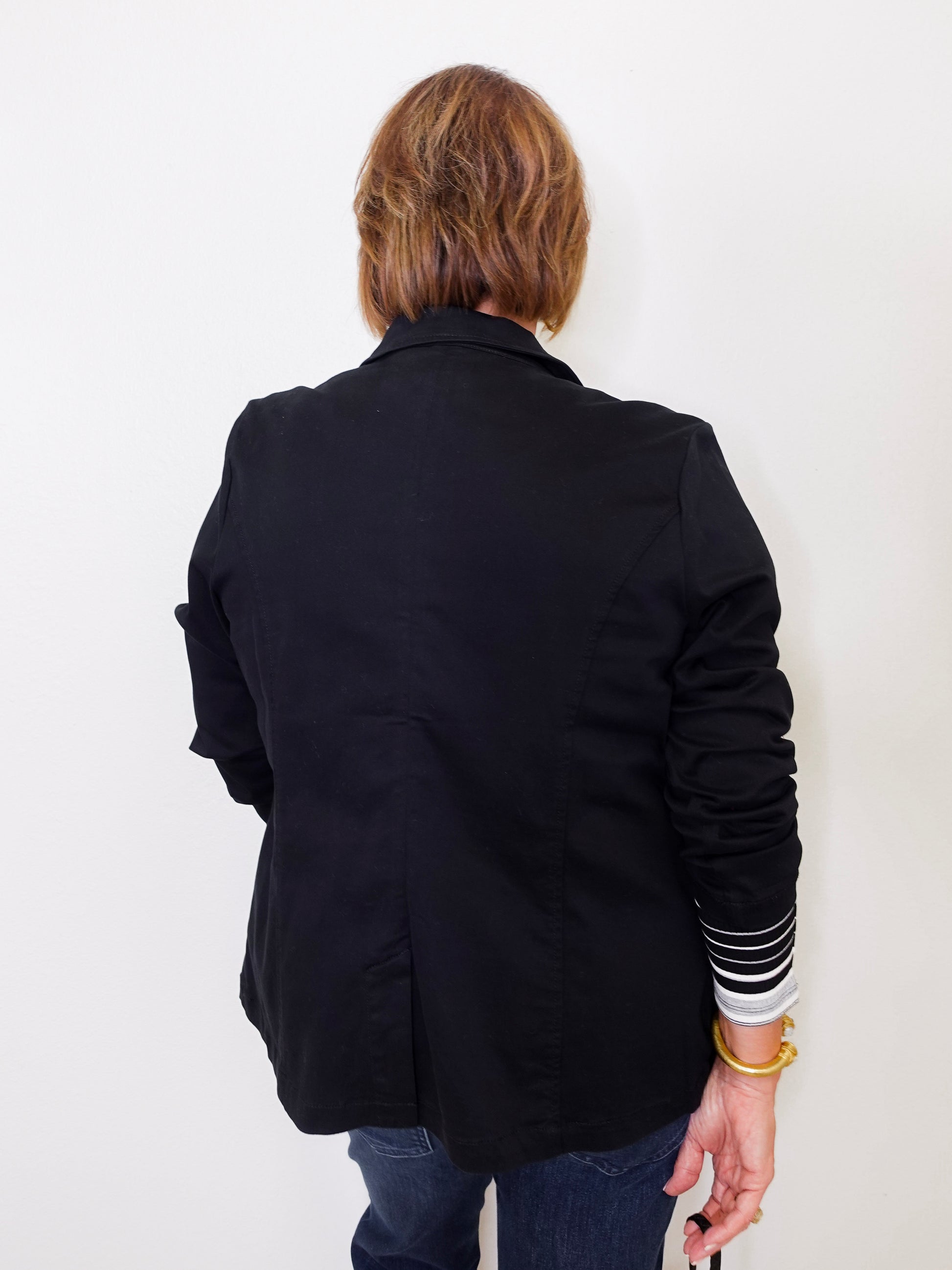 Person wearing a black jacket with a white background